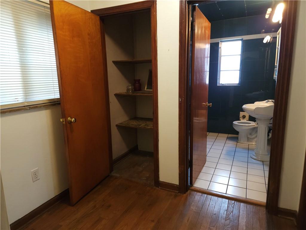 605 McCoy Road McKees Rocks, PA 15136 - Photo 29 of 39 a view of a hallway with wooden floor and a bathroom