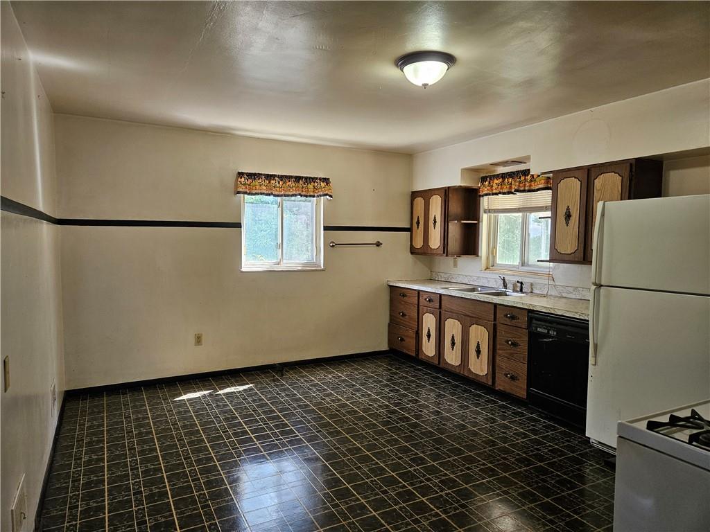 605 McCoy Road McKees Rocks, PA 15136 - Photo 3 of 39 a kitchen with granite countertop a refrigerator and a stove top oven
