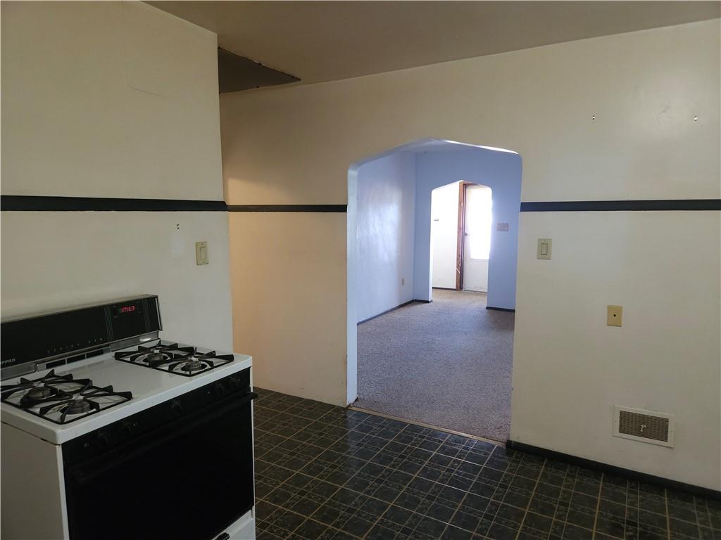 605 McCoy Road McKees Rocks, PA 15136 - Photo 38 of 39 a kitchen with a stove and a refrigerator