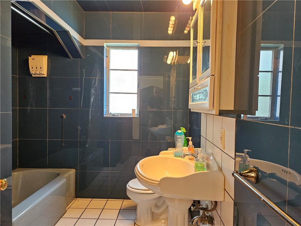 605 McCoy Road McKees Rocks, PA 15136 - Photo 7 of 39 a bathroom with a sink and mirror with bathtub