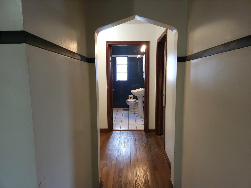 605 McCoy Road McKees Rocks, PA 15136 - Photo 10 of 39 a view of a hallway with wooden floor and bedroom with wooden floor