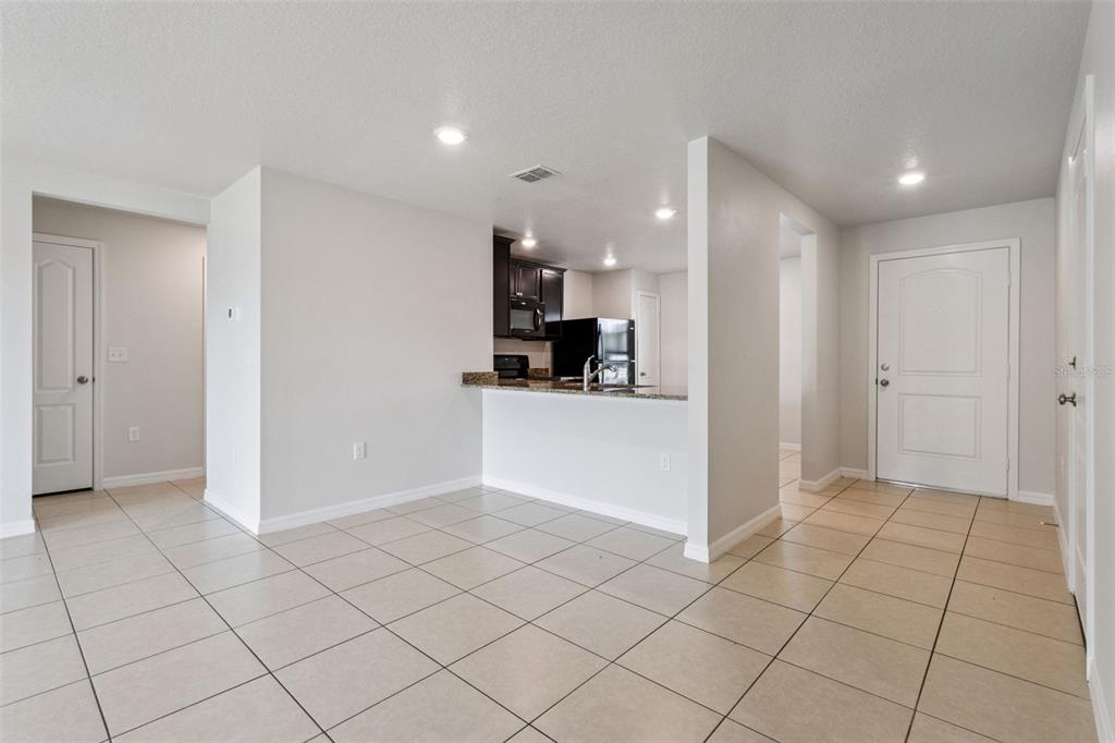 1613 Orne Street Mascotte, FL 34753 - Photo 12 of 31 a view of a kitchen with kitchen island granite countertop refrigerator and sink