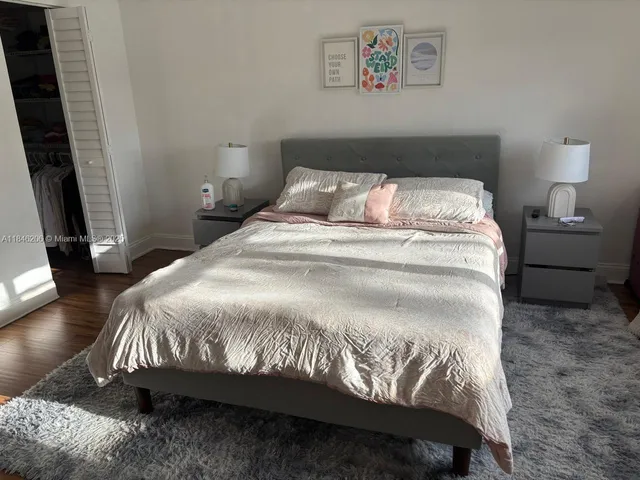 a large bed sitting in a bedroom next to a window