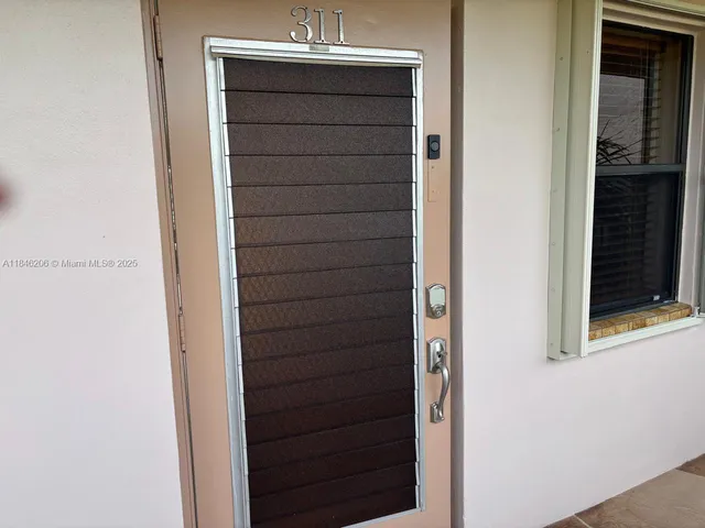 a bathroom with a granite countertop toilet sink and mirror