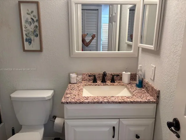 a kitchen with stainless steel appliances granite countertop a refrigerator and a stove