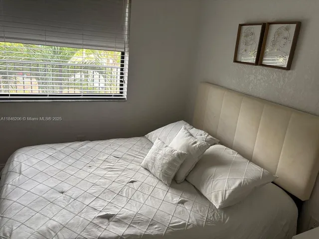 a bedroom with a bed and a shower