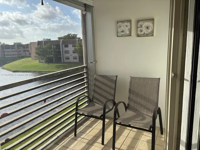 a view of a chairs and table in the balcony