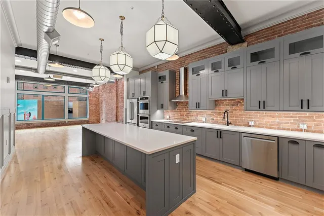 a large kitchen with lots of counter space sink and appliances