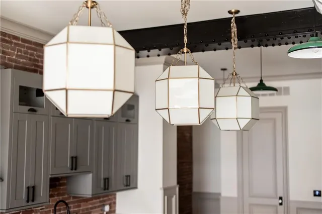 a kitchen with stainless steel appliances granite countertop a sink and a white cabinets