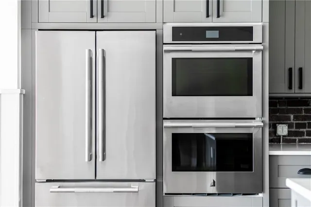 a view of white cabinets and a wooden floor