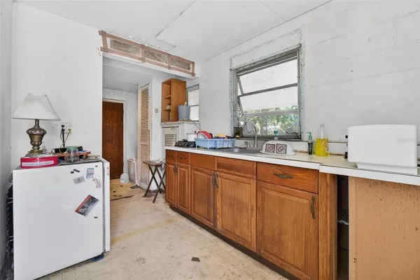a utility room with cabinets washer and dryer