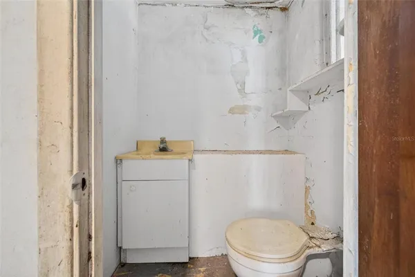 a white toilet sitting next to a shower