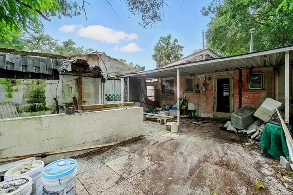 a view of house with backyard outdoor seating and patio