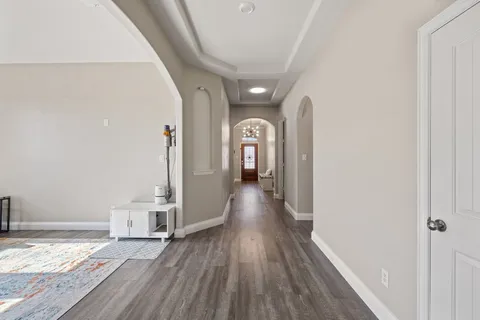 a view of a hallway with wooden floor