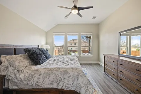 a large bed sitting in a bedroom next to a window