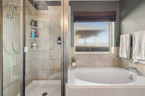a bath tub sitting next to a shower