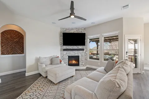 a living room with furniture a fireplace and a flat screen tv