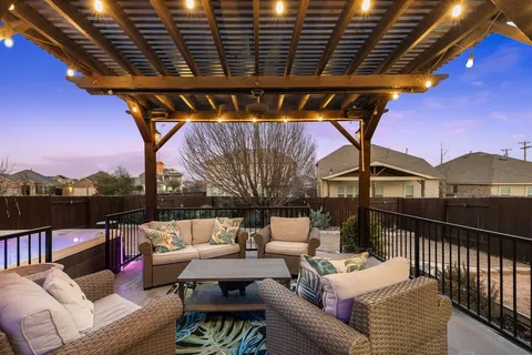 a roof deck with couch and chairs