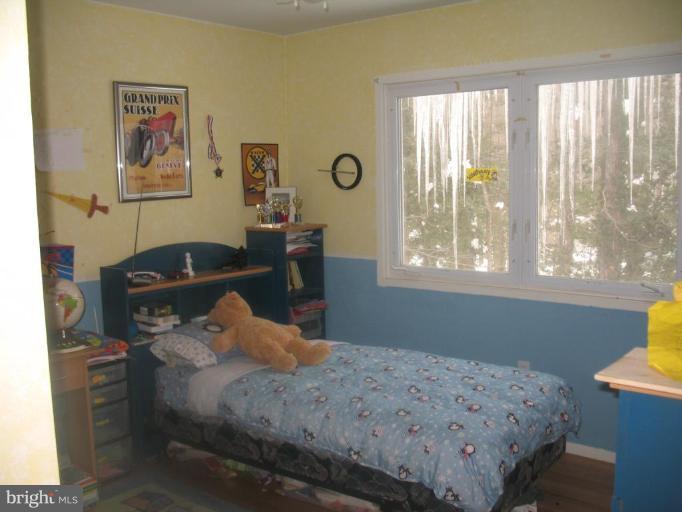 11320 Myrtle Lane Reston, VA 20191 - Photo 4 of 7 a bedroom with a bed and wooden floor