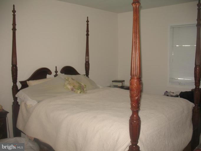 11320 Myrtle Lane Reston, VA 20191 - Photo 5 of 7 a bedroom with a bed and window