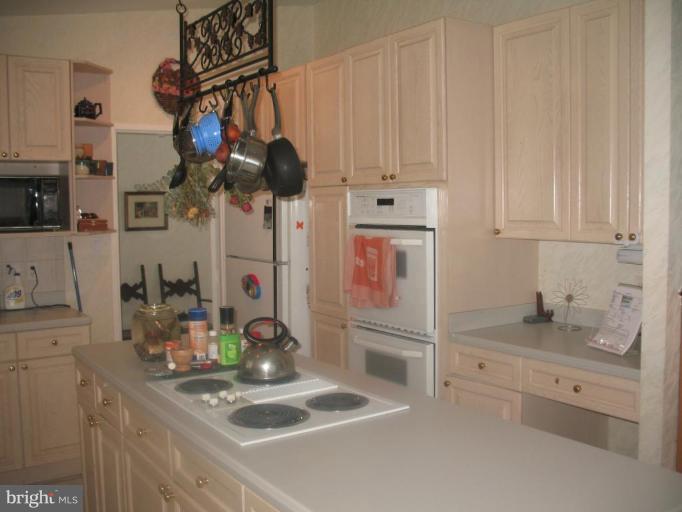 11320 Myrtle Lane Reston, VA 20191 - Photo 7 of 7 a kitchen with white cabinets and appliances