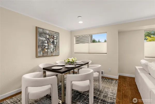 a dining room with furniture and wooden floor