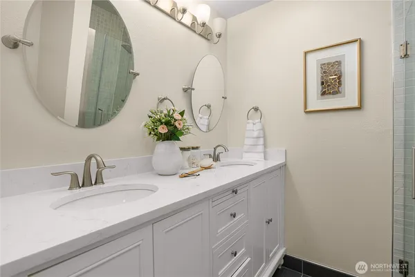 a bathroom with a double vanity sink and a mirror