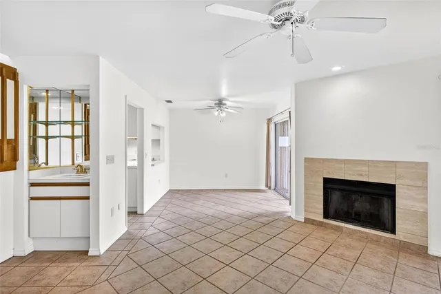 an empty room with fan and windows