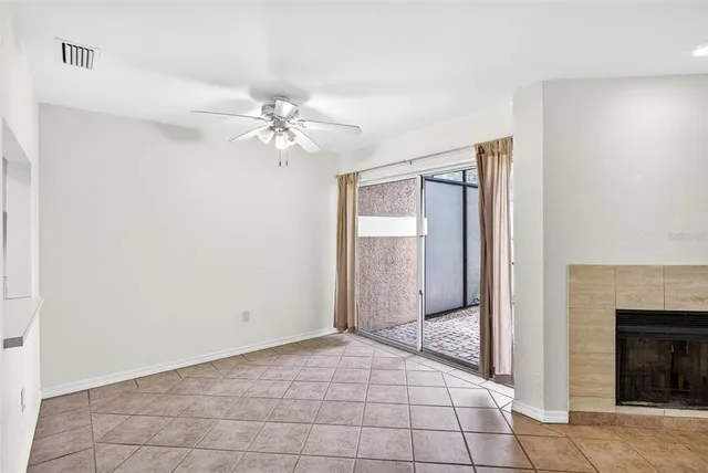 a view of a livingroom with a chandelier fan and fire place