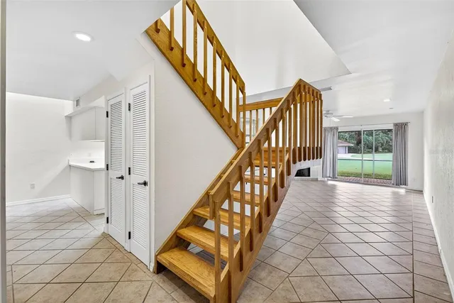 a view of entryway with wooden floor and stairs