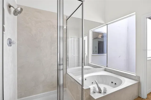 a bathroom with a tub and shower