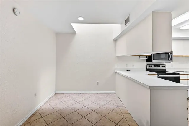 a view of a kitchen with electric appliances
