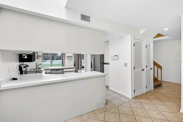 a kitchen with stainless steel appliances a sink and a refrigerator