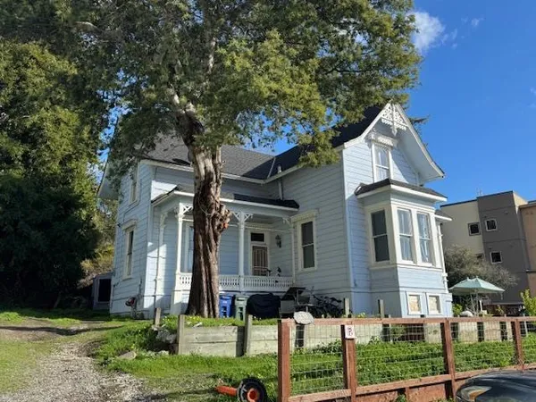 front view of a house with a tree