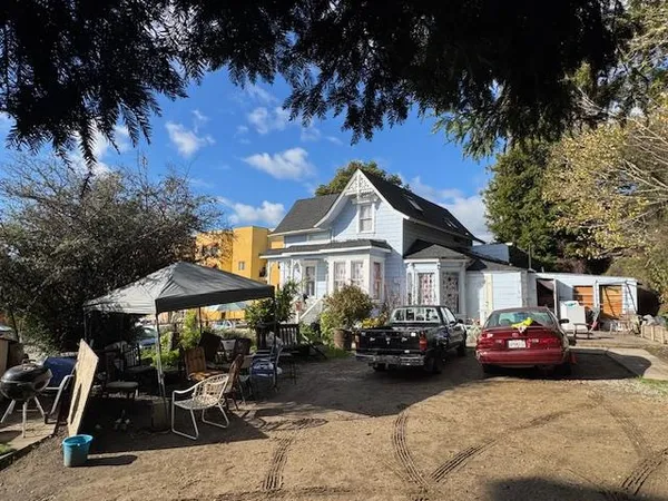 a group of cars parked in front of a house