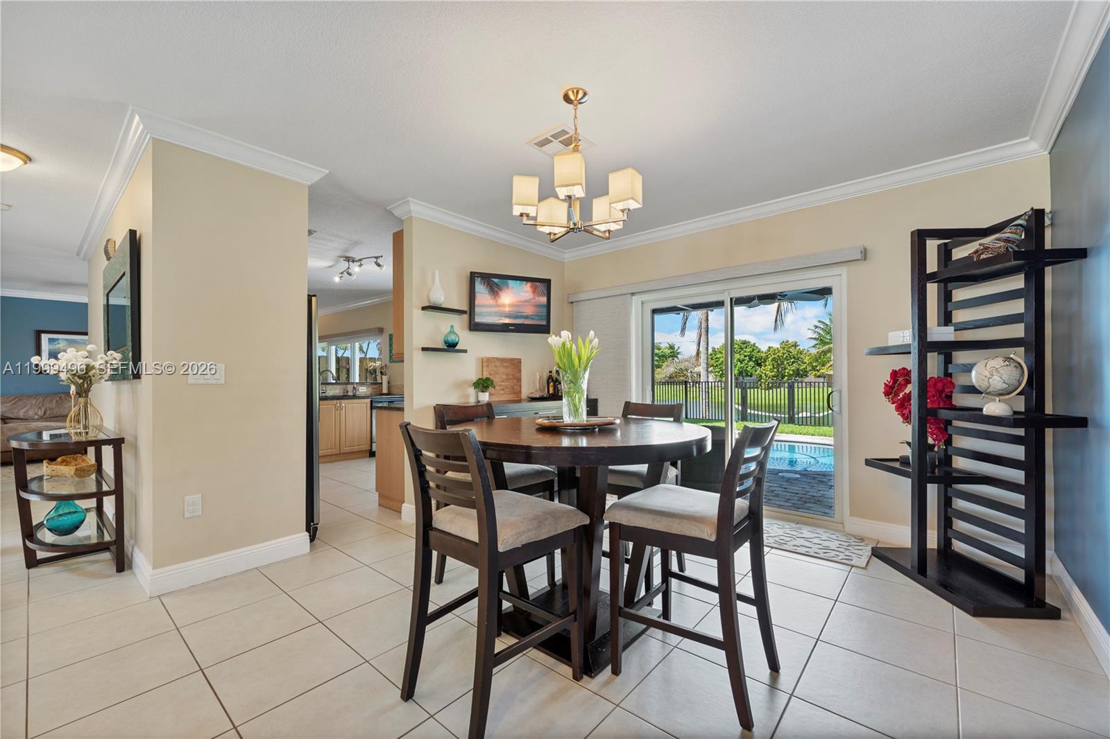 20918 Southwest 89th Path Cutler Bay, FL 33189 - Photo 11 of 47 a view of a dining room with furniture and a chandelier