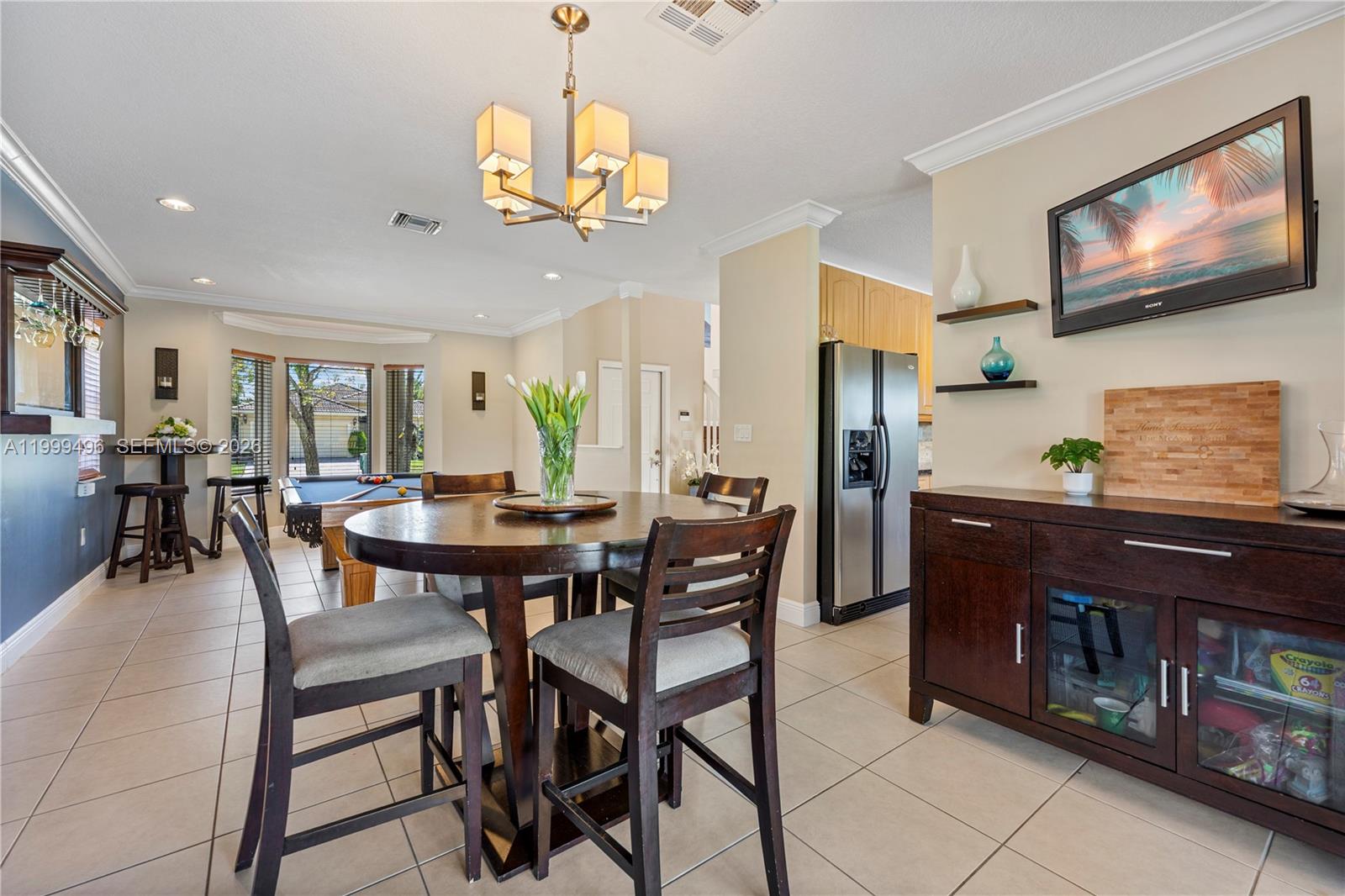20918 Southwest 89th Path Cutler Bay, FL 33189 - Photo 12 of 47 a view of a dining room with furniture and chandelier