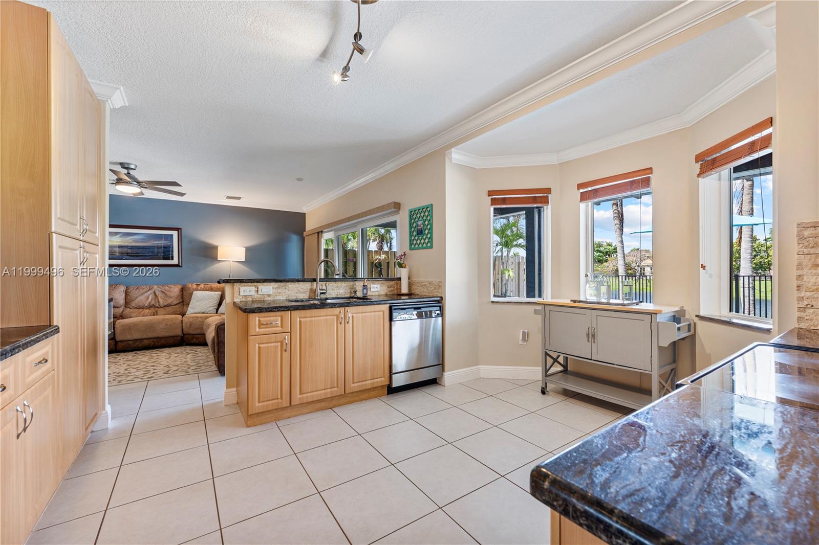 20918 Southwest 89th Path Cutler Bay, FL 33189 - Photo 13 of 47 a kitchen with stainless steel appliances granite countertop a stove a sink and a refrigerator