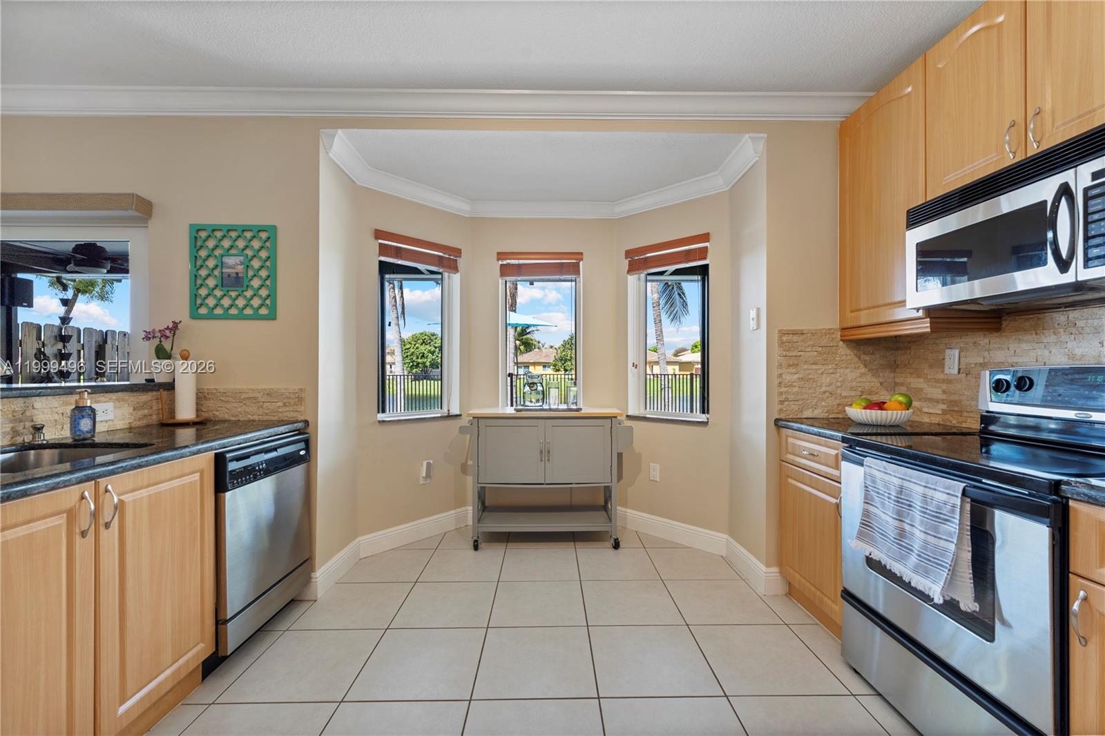 20918 Southwest 89th Path Cutler Bay, FL 33189 - Photo 14 of 47 a kitchen with stainless steel appliances granite countertop a stove a sink and a microwave