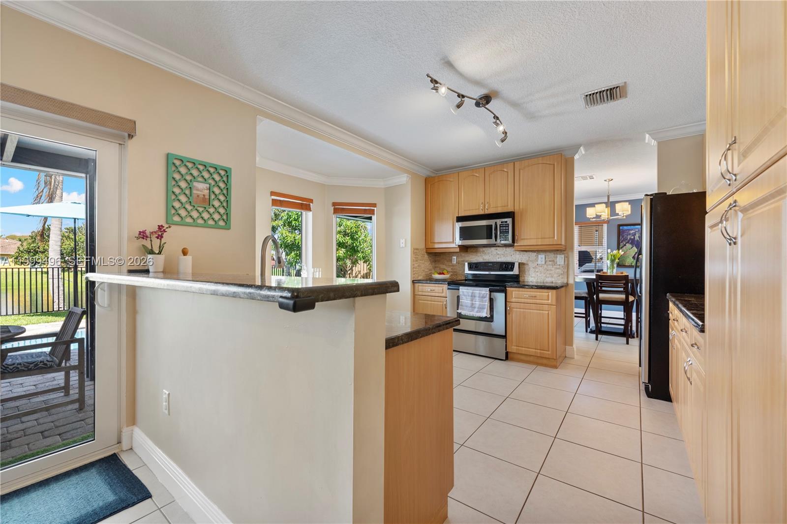 20918 Southwest 89th Path Cutler Bay, FL 33189 - Photo 16 of 47 a kitchen with stainless steel appliances granite countertop a refrigerator and a stove top oven