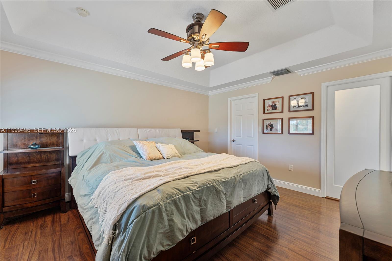20918 Southwest 89th Path Cutler Bay, FL 33189 - Photo 21 of 47 a bedroom with bed and a chandelier