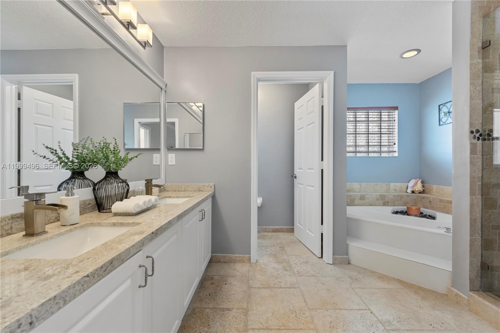 20918 Southwest 89th Path Cutler Bay, FL 33189 - Photo 23 of 47 a bathroom with a granite countertop sink and a bathtub
