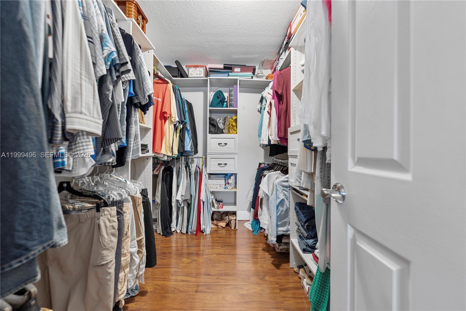 20918 Southwest 89th Path Cutler Bay, FL 33189 - Photo 25 of 47 a view of walk in closet with clothes