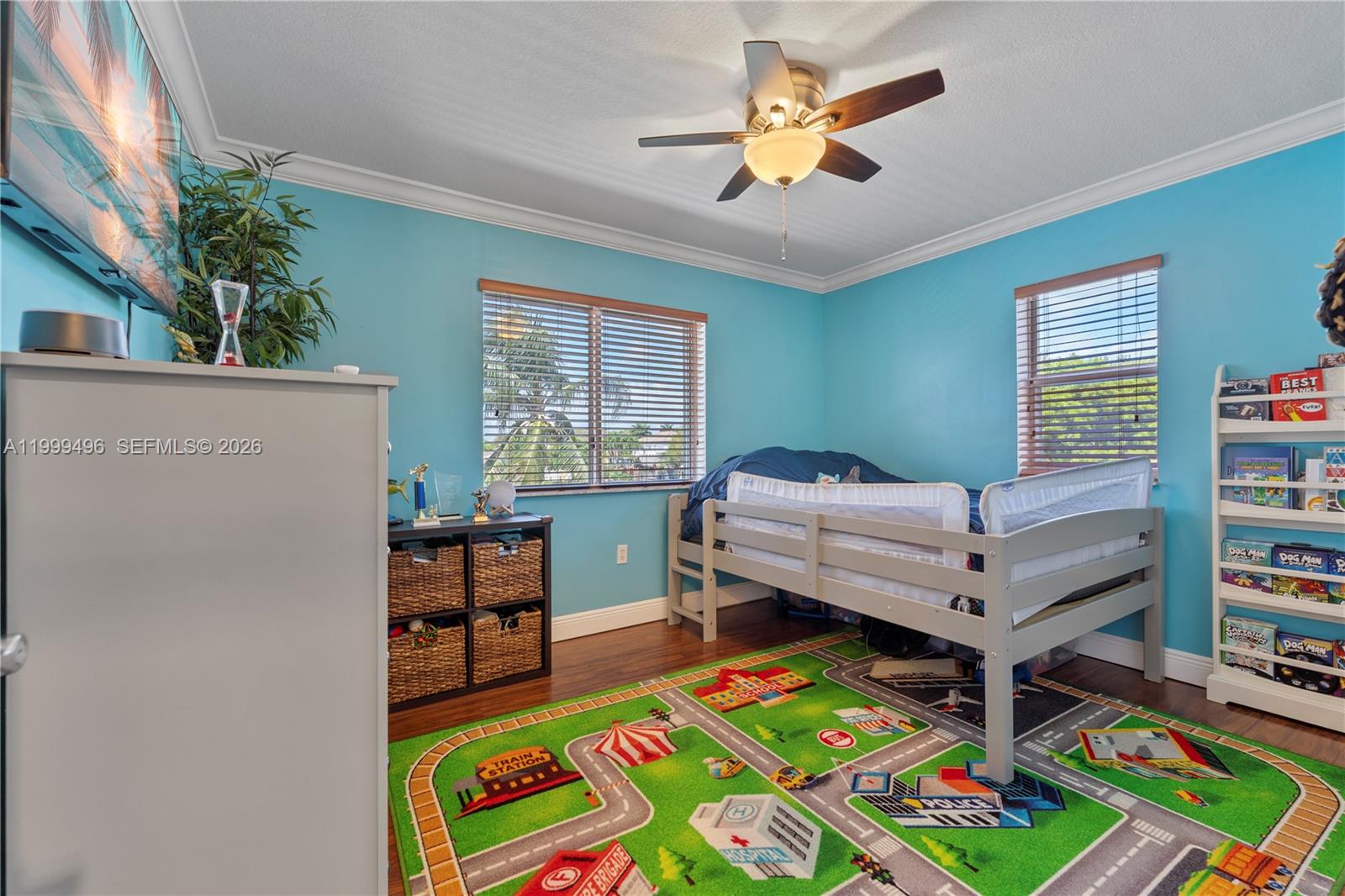 20918 Southwest 89th Path Cutler Bay, FL 33189 - Photo 29 of 47 a bedroom with a bed and a bookshelf