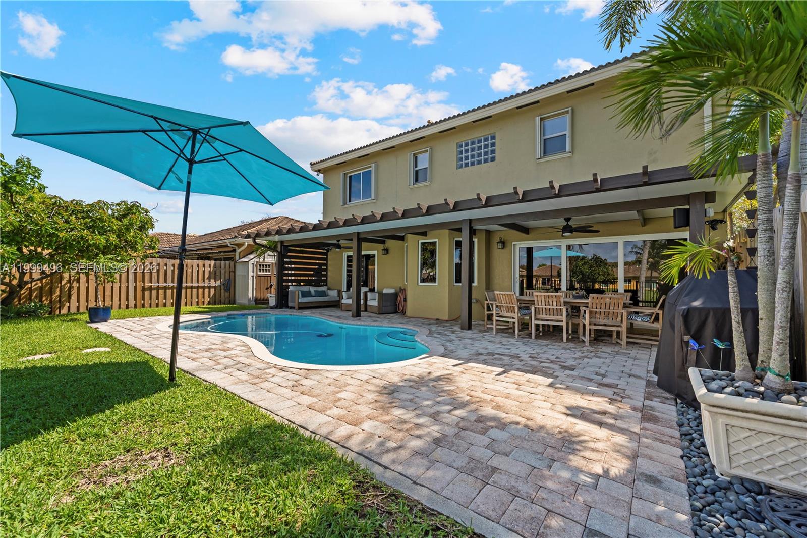 20918 Southwest 89th Path Cutler Bay, FL 33189 - Photo 36 of 47 a view of a house with backyard porch and sitting area