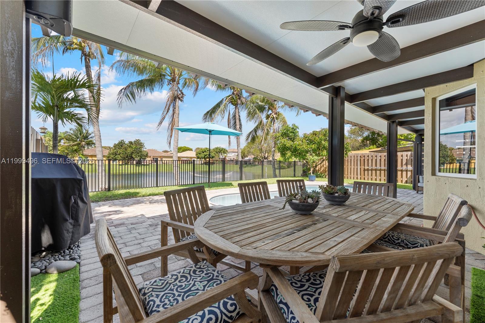 20918 Southwest 89th Path Cutler Bay, FL 33189 - Photo 39 of 47 a view of a patio with a table chairs and a table