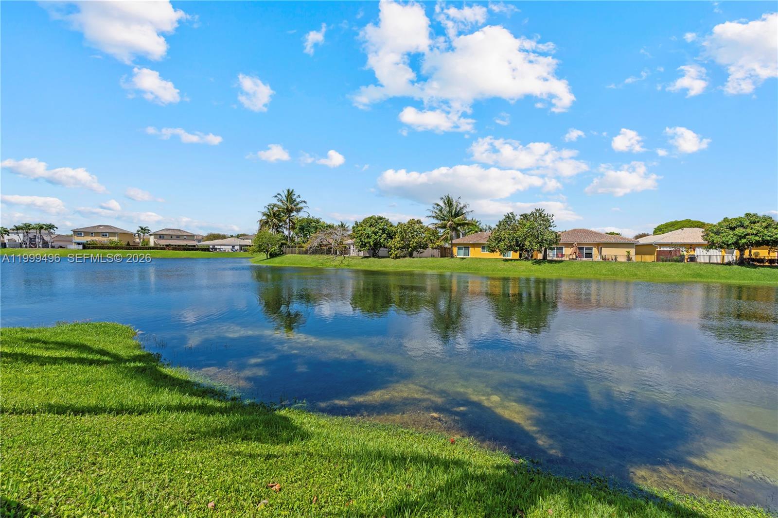 20918 Southwest 89th Path Cutler Bay, FL 33189 - Photo 40 of 47 a view of a lake with houses in the back