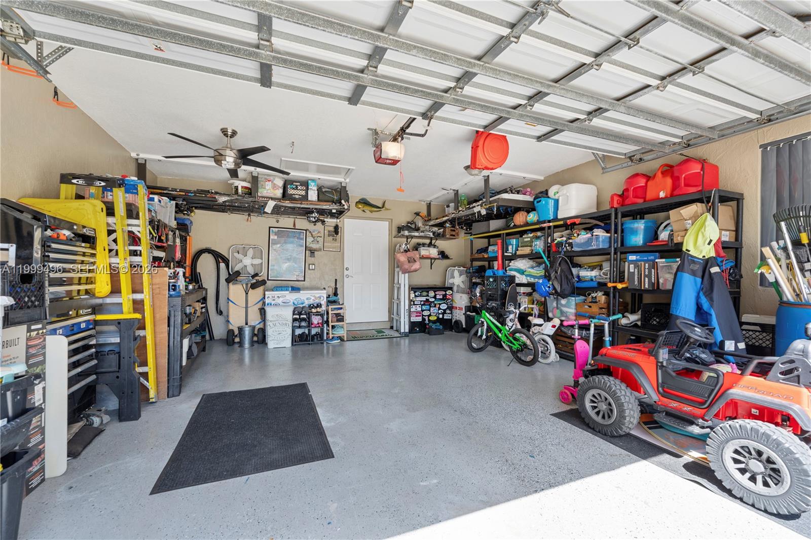 20918 Southwest 89th Path Cutler Bay, FL 33189 - Photo 41 of 47 a view of a garage with a bike and car