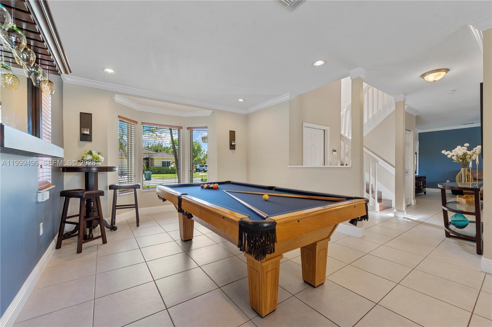 20918 Southwest 89th Path Cutler Bay, FL 33189 - Photo 9 of 47 a room with furniture a table and a large window