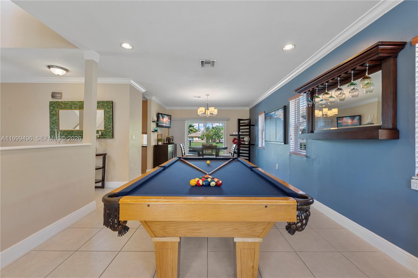 20918 Southwest 89th Path Cutler Bay, FL 33189 - Photo 10 of 47 a room with wooden floor pool table and windows